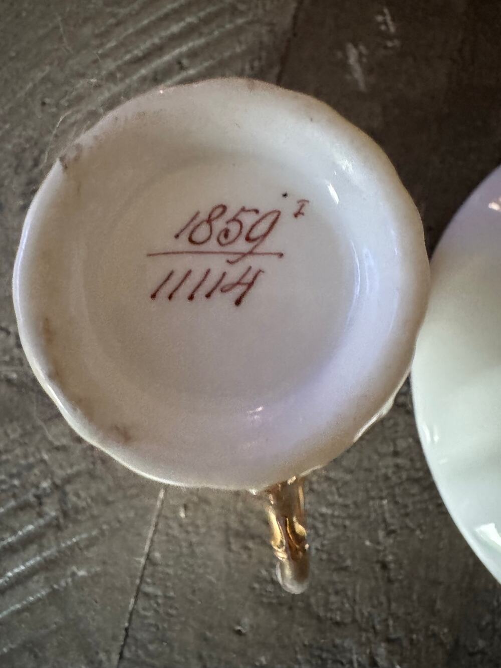 antique Demitasse cup and saucer with gold trim